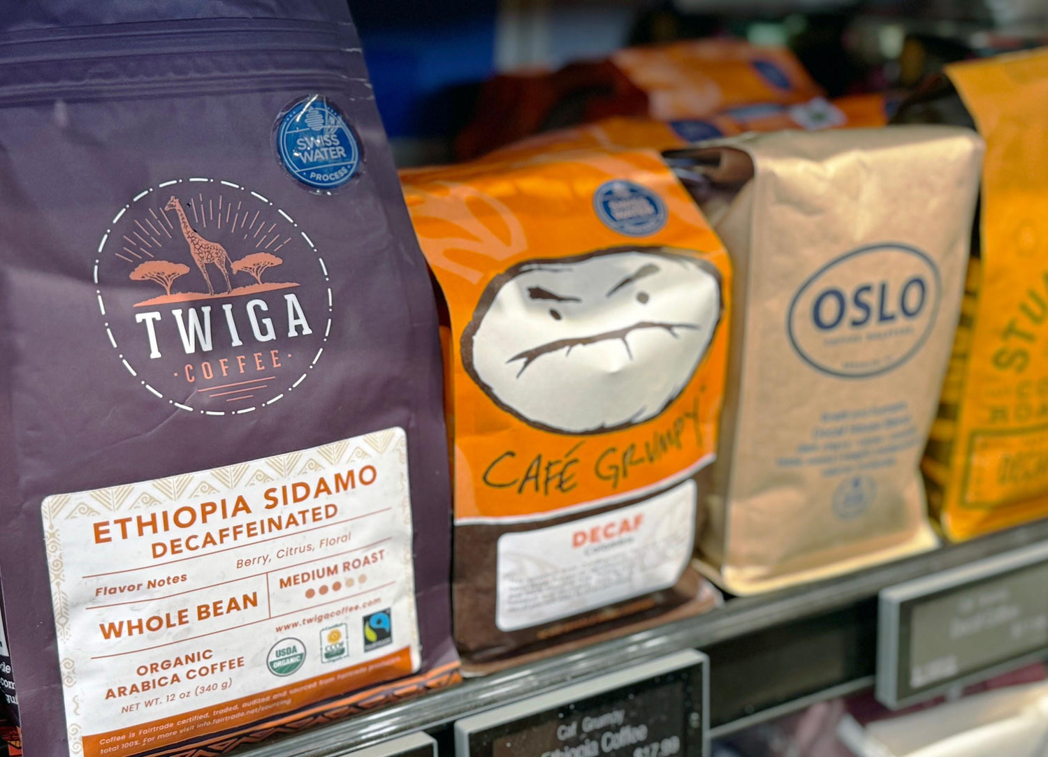 Coffee bags from Twiga Coffee, Cafe Grumpy, and Oslo on a store shelf.